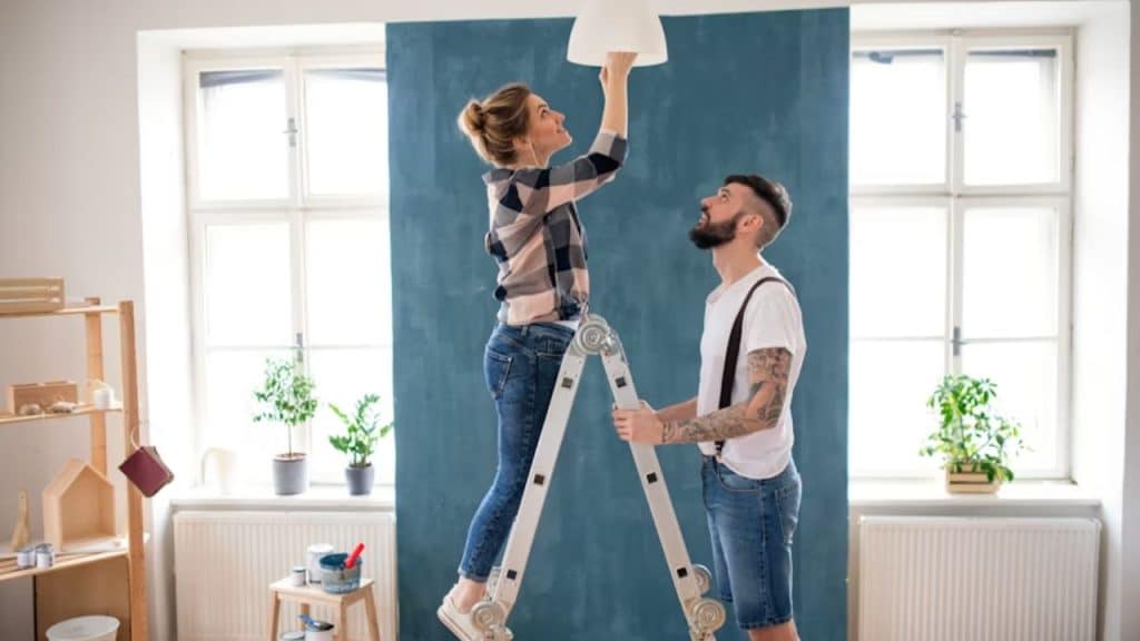 Couple supporting each other equally during a home improvement project.