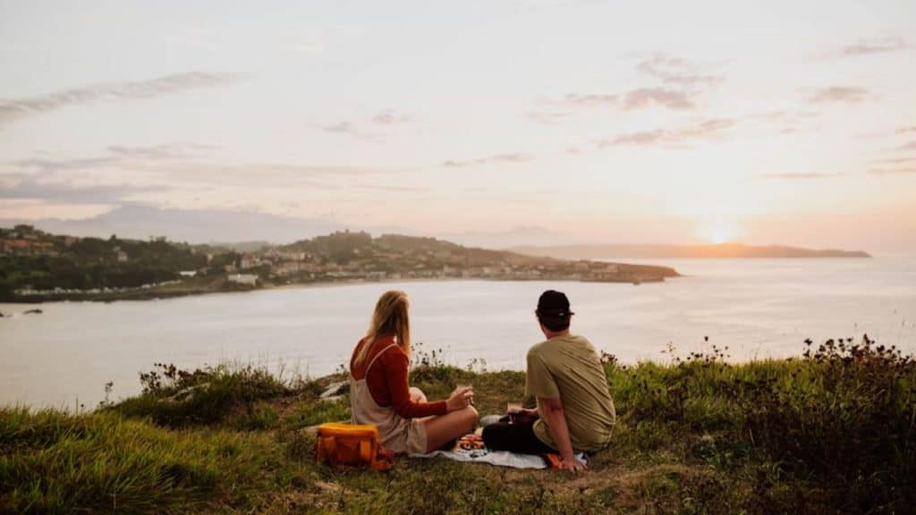 Couple watching the sunset while having a serious conversation.