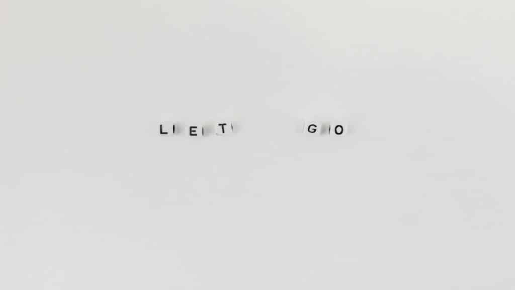 Pieces of dice saying “let go”.