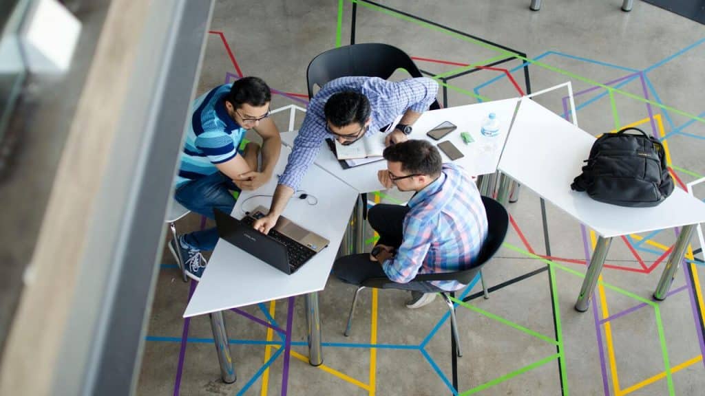 Three colleagues having a meeting at work.