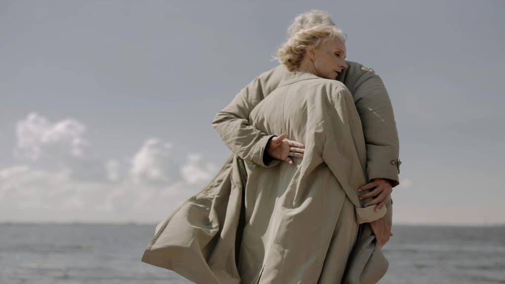 An older couple hugging each other.