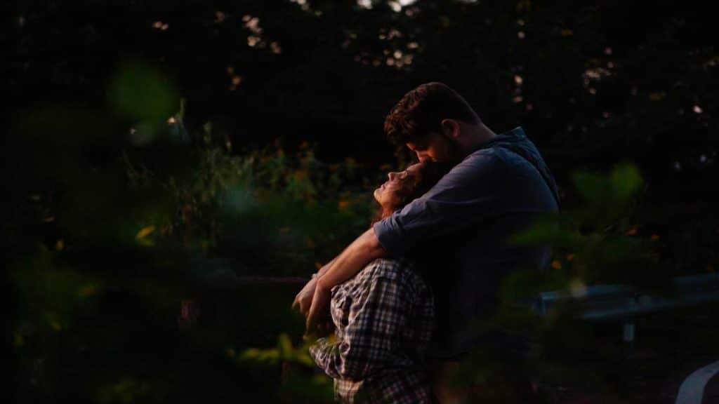 A couple hugging during sunset.