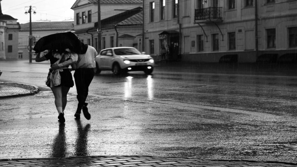 A couple crossing the street.