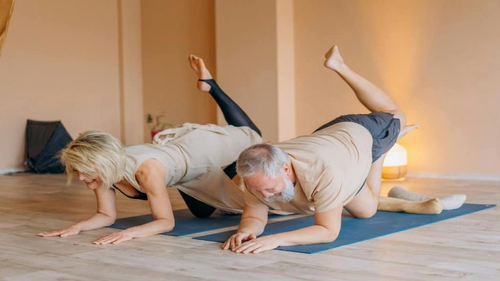A couple doing yoga together.