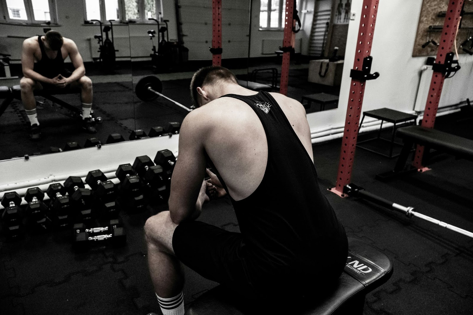 A man just sitting at the gym.