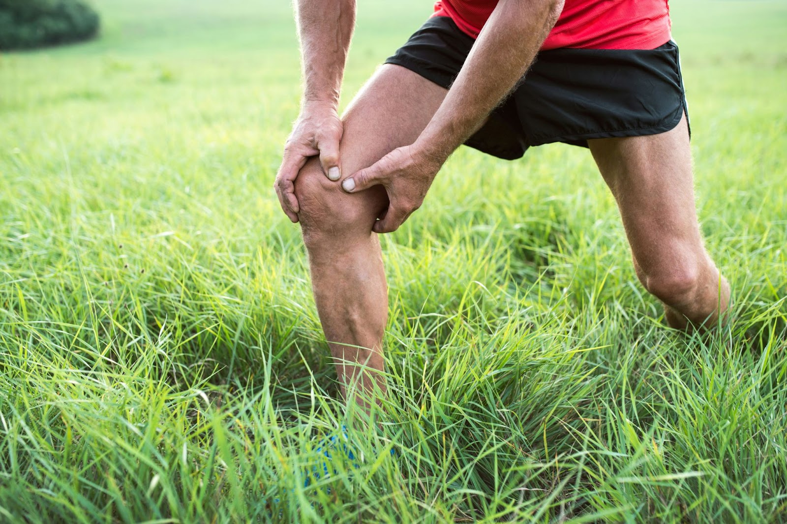 A man holding his knee.