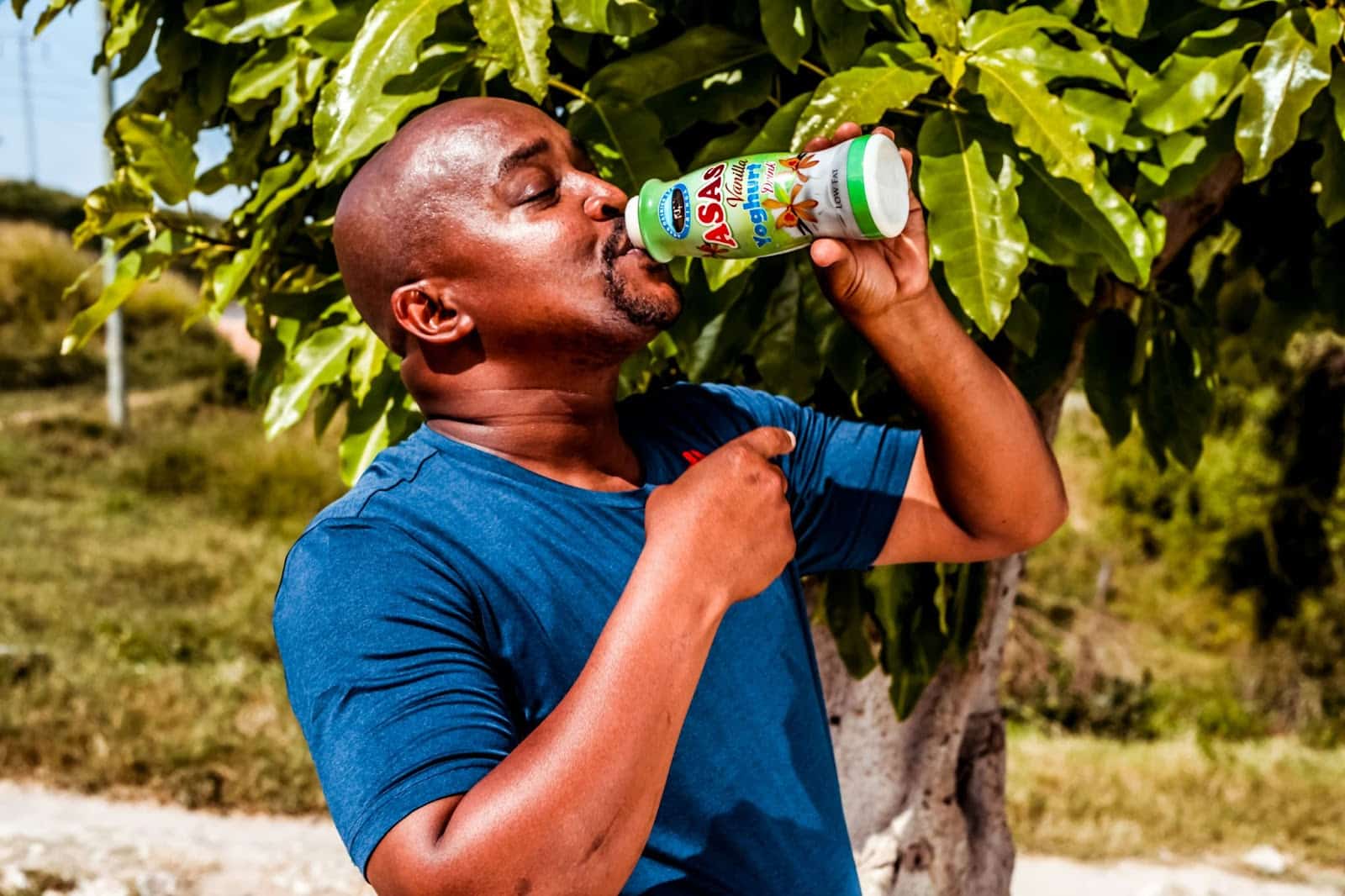 Man drinking a yogurt drink instead of water.