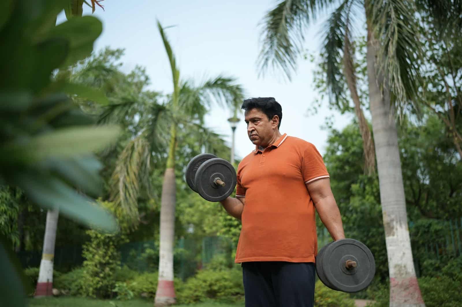 Man carrying weights outdoors.