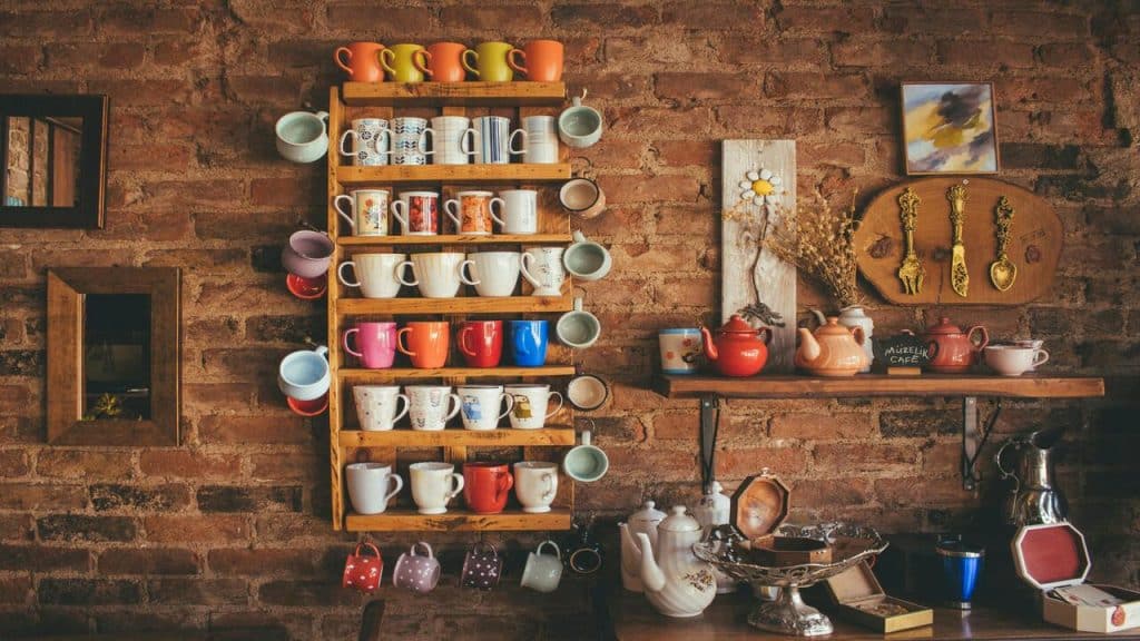 Different mugs on a floating rack.