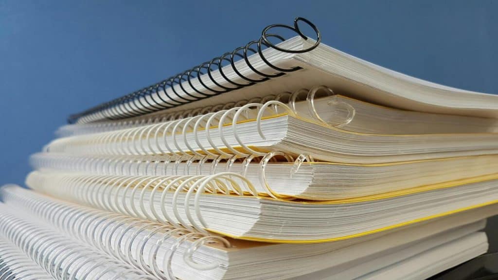 Spiral notebooks on top of each other.