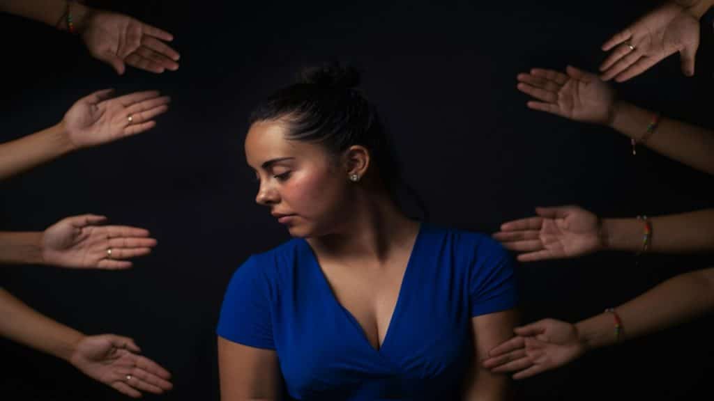 A person with hands around her.