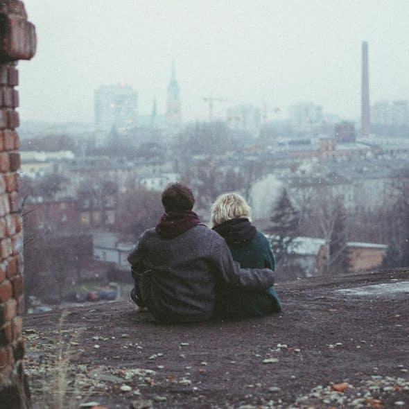 A man hugging a woman.