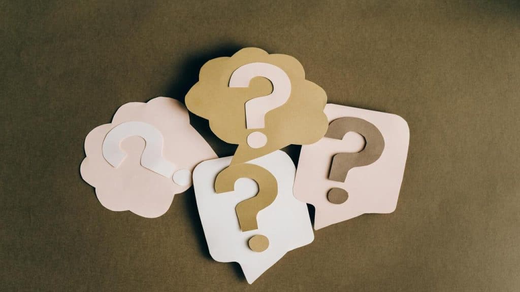 Cut-out question marks on brown paper
