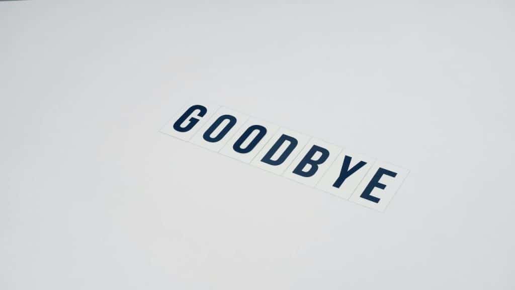 The word “goodbye” on a white surface