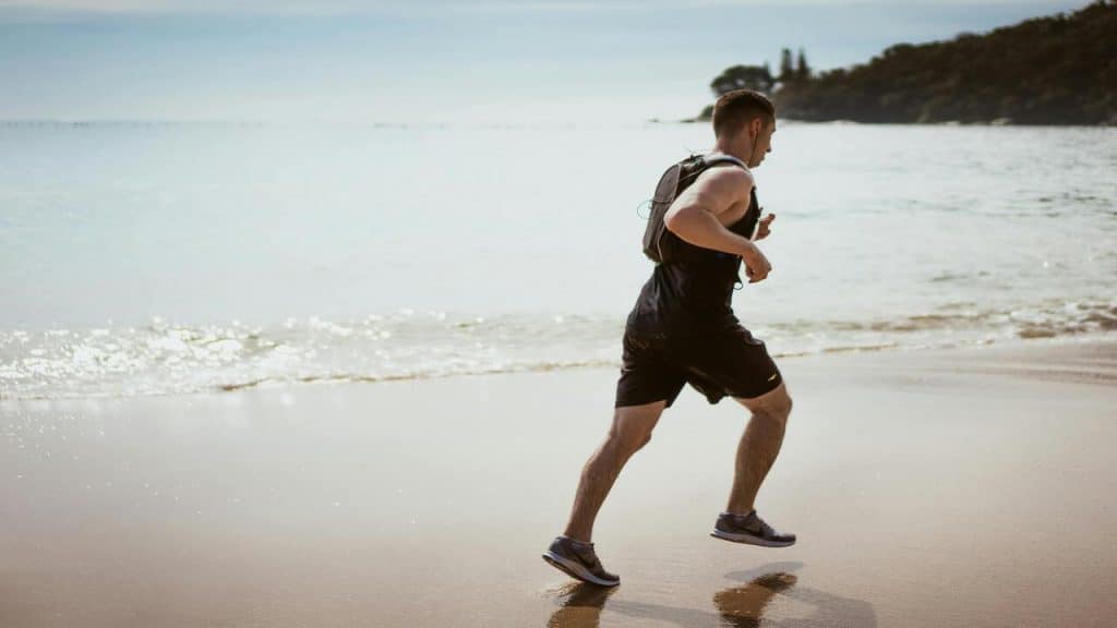 A man jogging by the beach