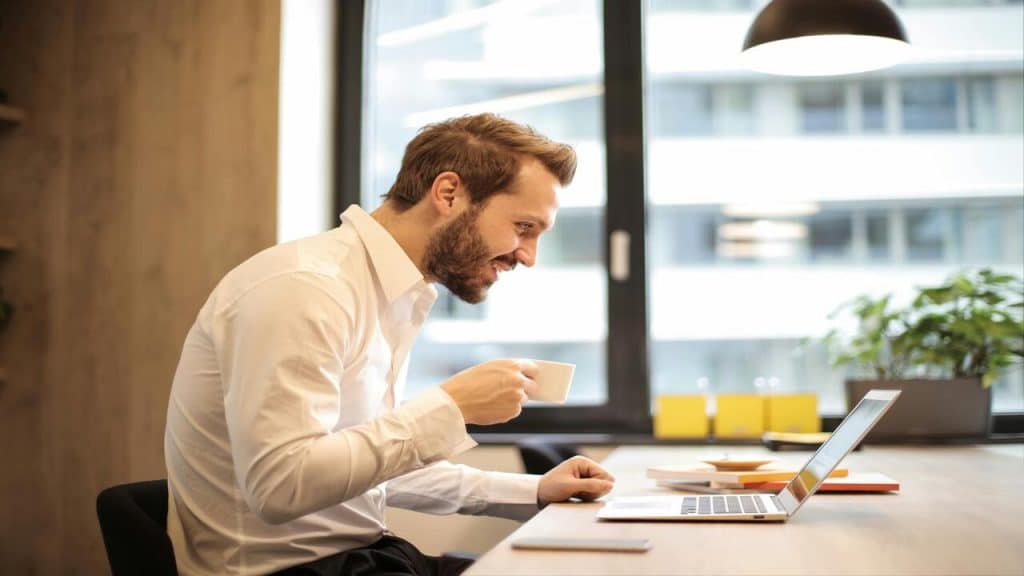 A man smiling while working in the office
