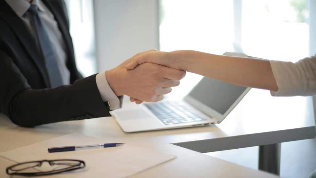 Two people shaking hands at work