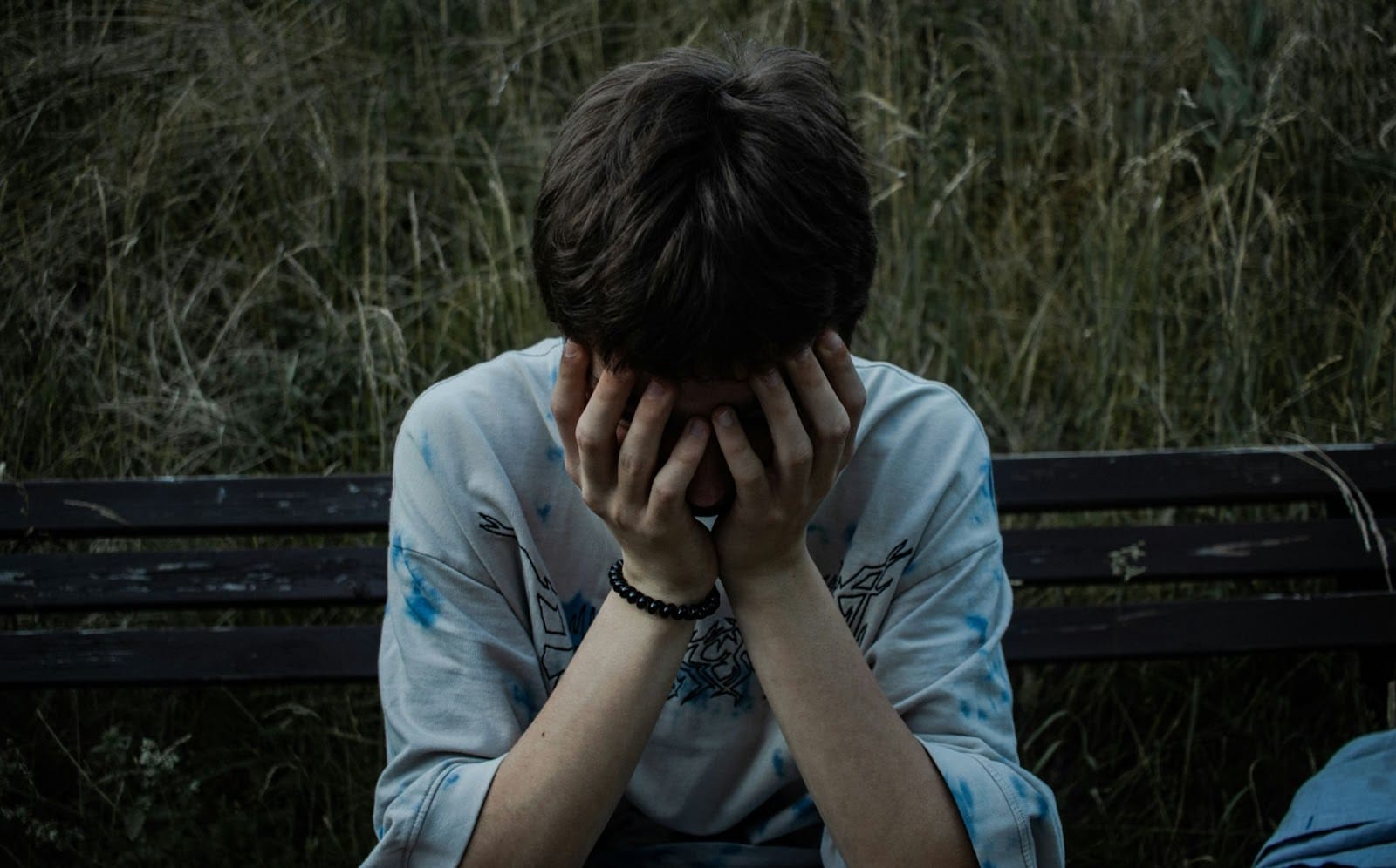 A man covering his face