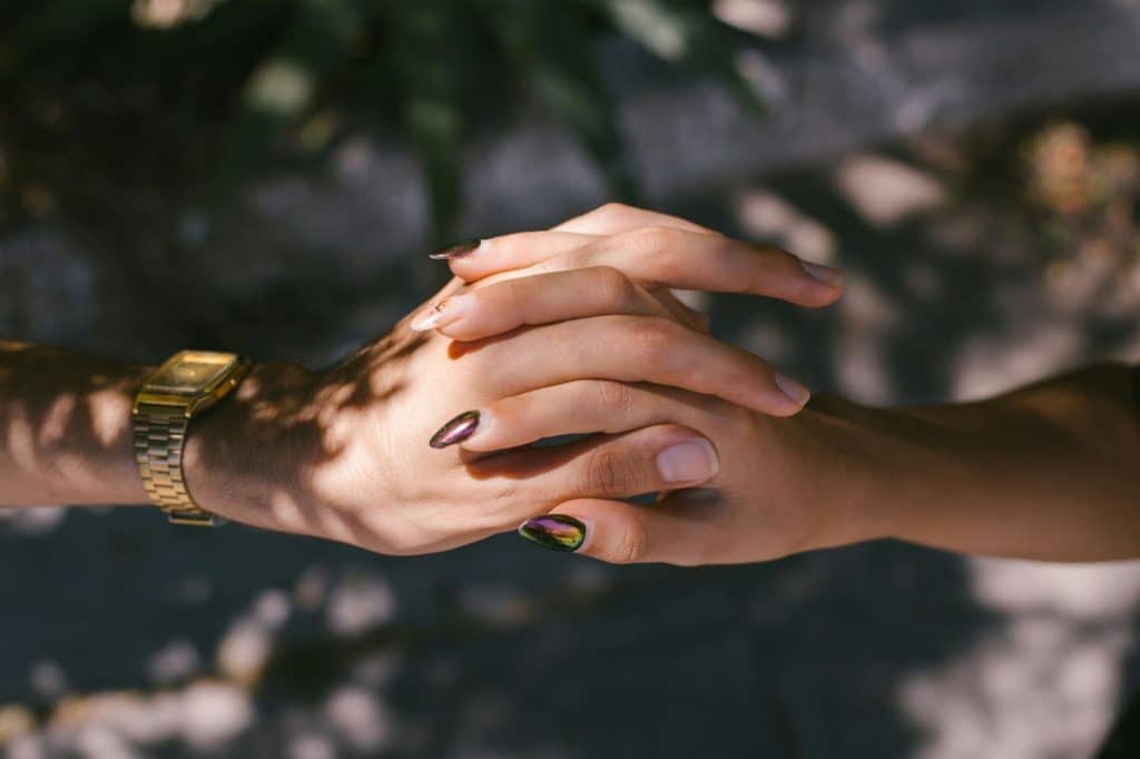 Two person holding each other’s hands