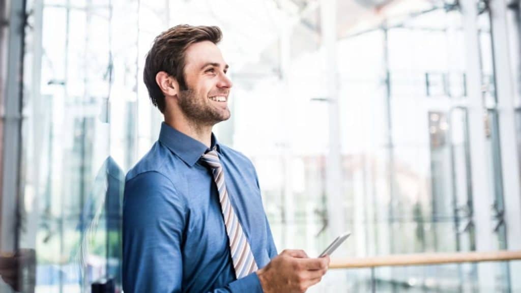 A man smiling while looking at his partner at a distance