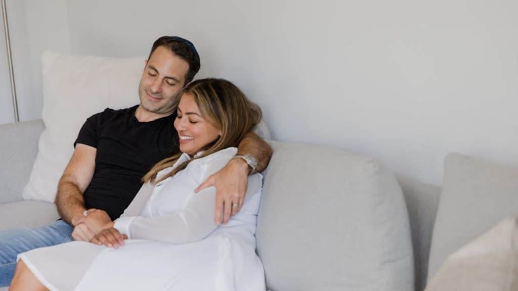Couple holding hands during a heartfelt moment at home