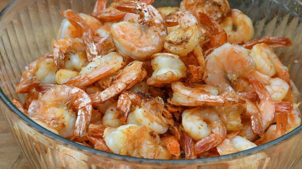 A bowl of cooked shrimp.