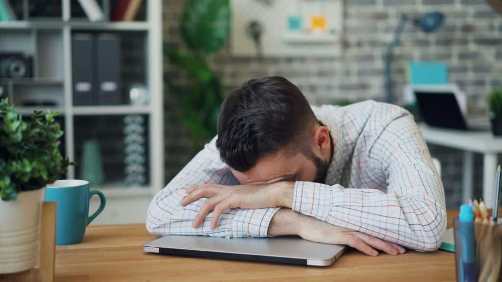 A picture of a man resting his head on the table