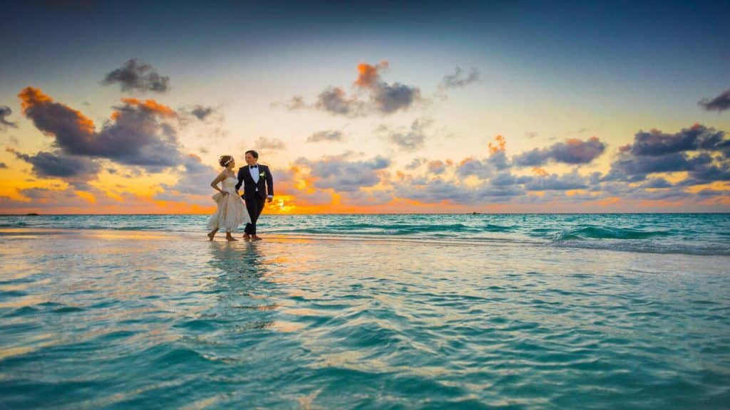 Newlyweds walking on body of water