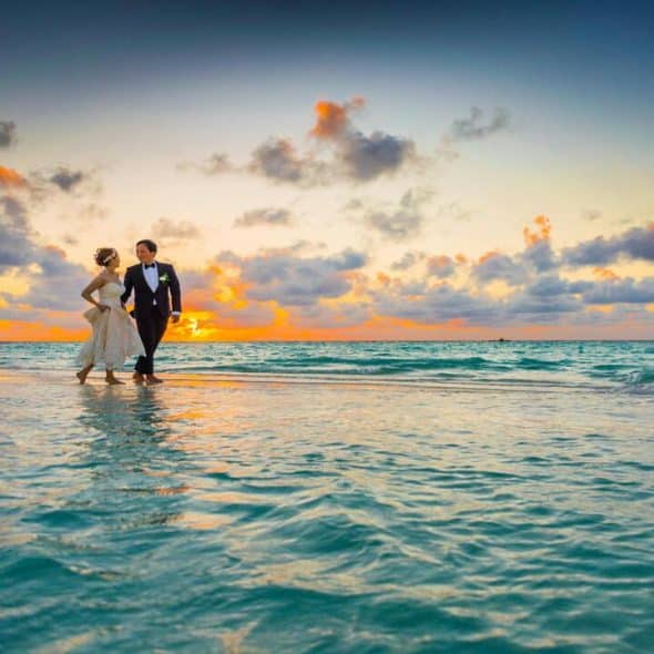 Newlyweds walking on body of water