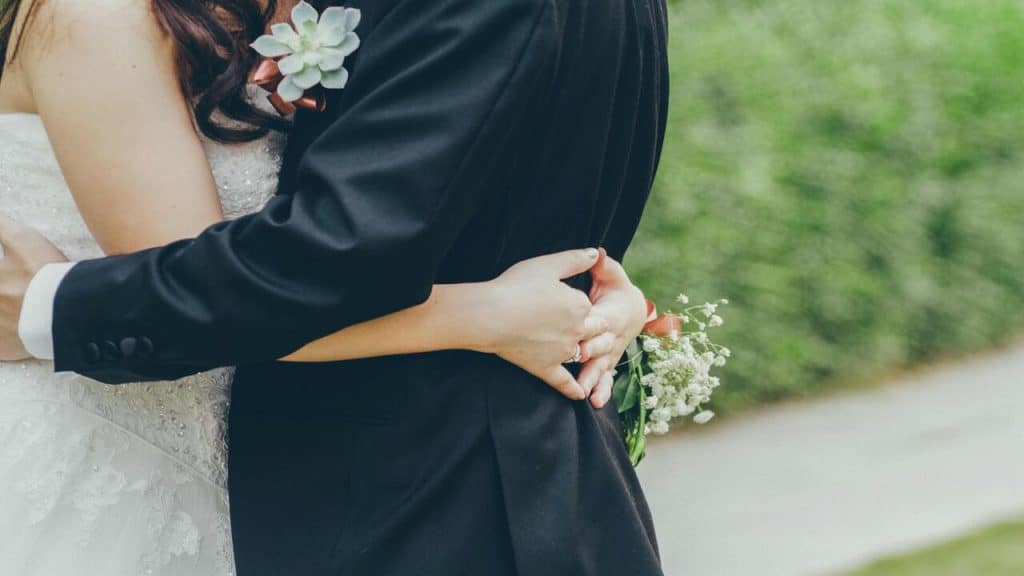 Newlyweds hugging during their wedding