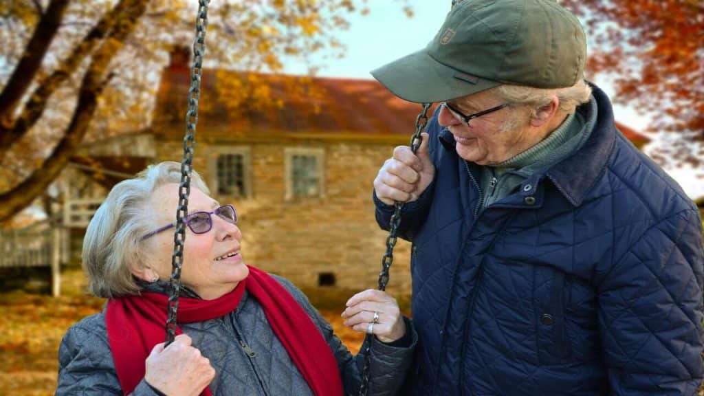 An elderly couple looking at each other
