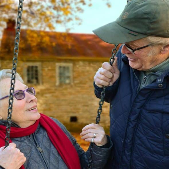 An elderly couple looking at each other