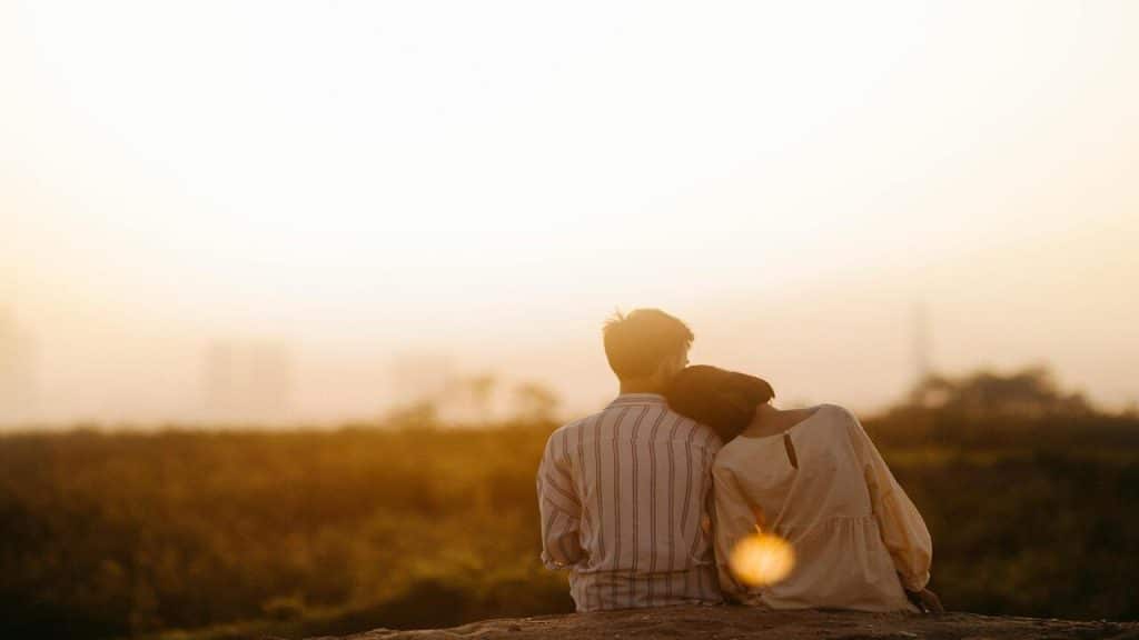 A woman leaning on a man’s shoulder