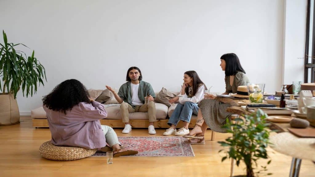 Friends sitting on the living room and talking