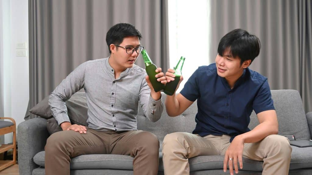Two men drinking an alcohol