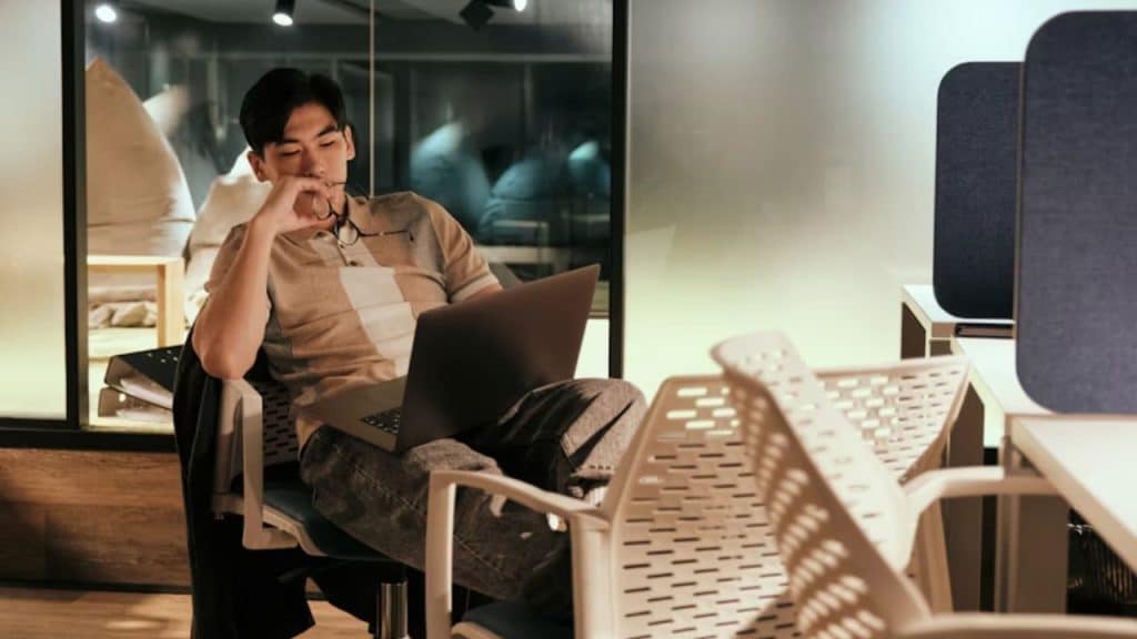 Man touching a phone screen while video chatting with his partner.