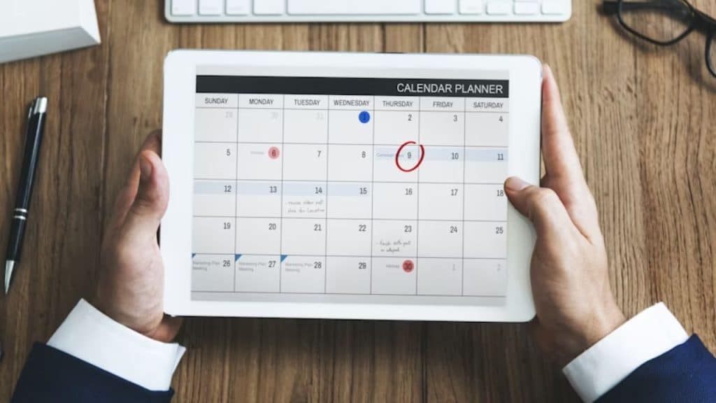 Man circling a future date on a calendar.