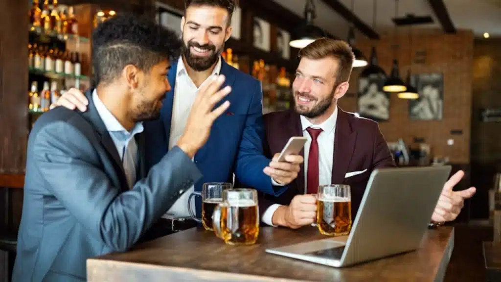 Man politely declining a drink offer at a bar after work.