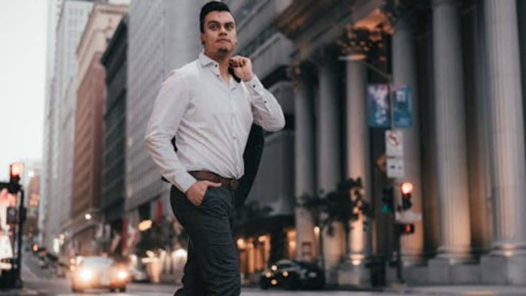 Man walking confidently away from a bar with a satisfied look.