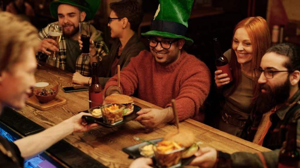 Man confidently saying no to a drink and accepts food instead.