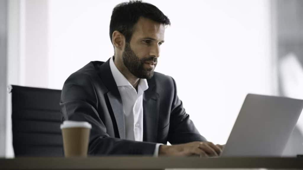 Man reading HR policy on office computer.