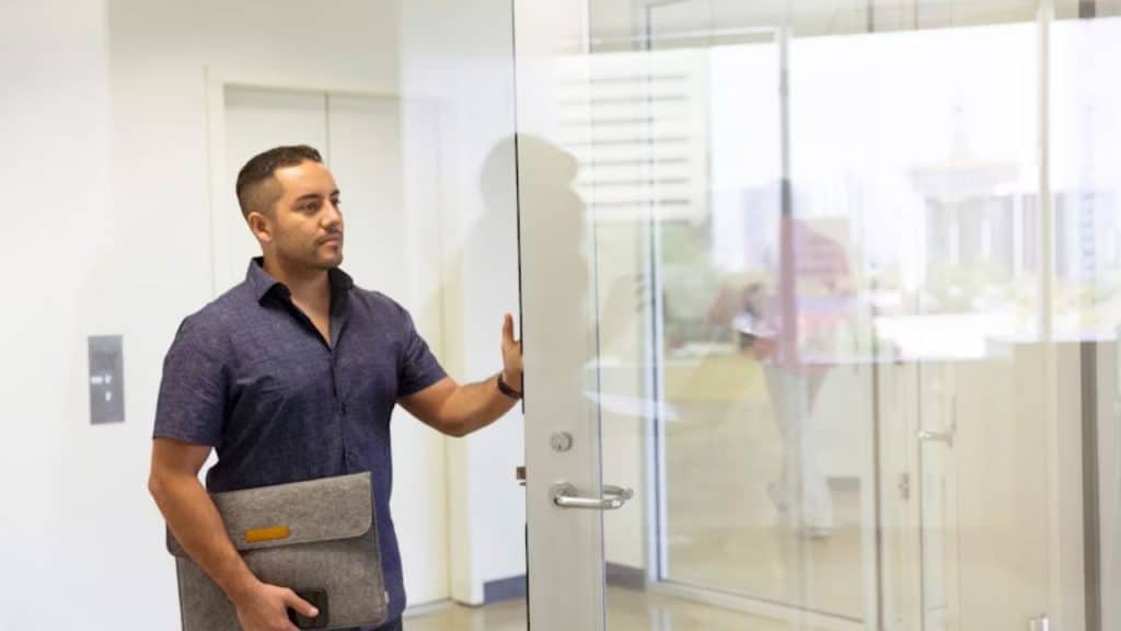 Man approaching HR office with a confident, professional demeanor.