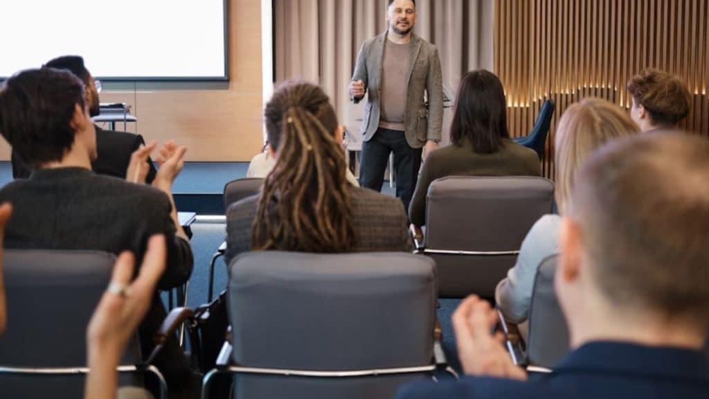 Professional man presenting confidently to a group of coworkers.
