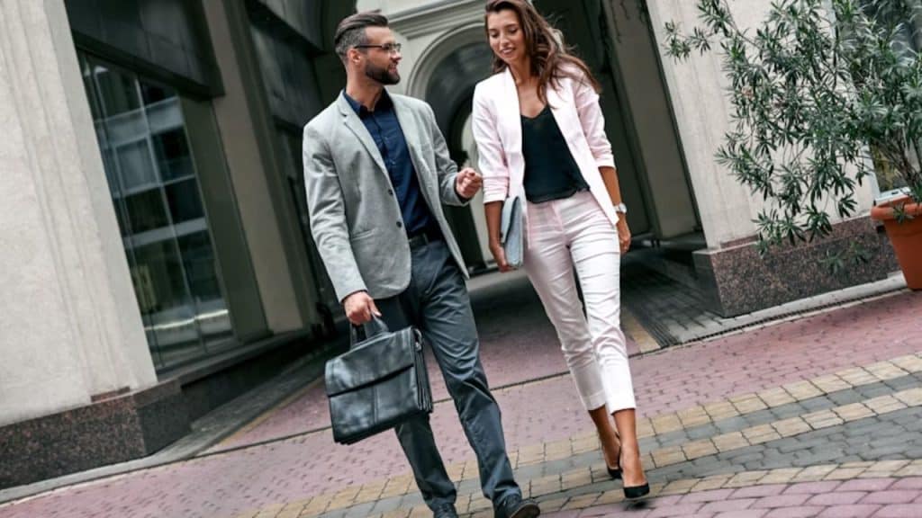 Happy couple walking to work together, confident and composed.