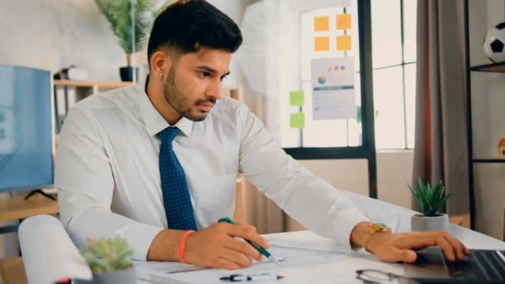 Man organizing priorities on a laptop with both love and work on it.