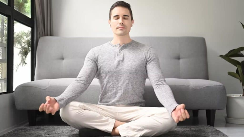 Man meditating alone in a quiet room.