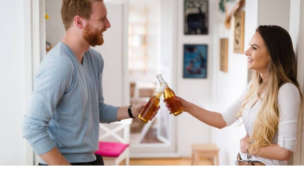Man toasting a small success with partner at home.
