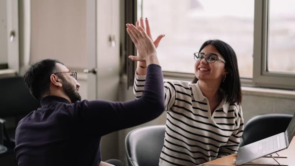 Man cheering on partner at her presentation or project.