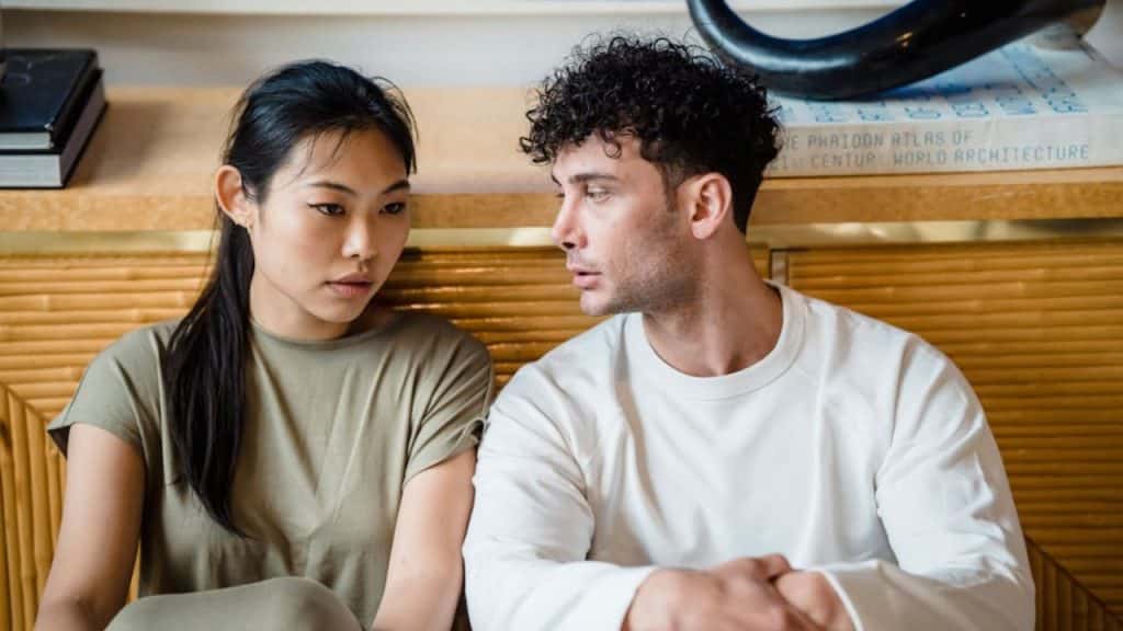 Couple having a serious but calm discussion at home.