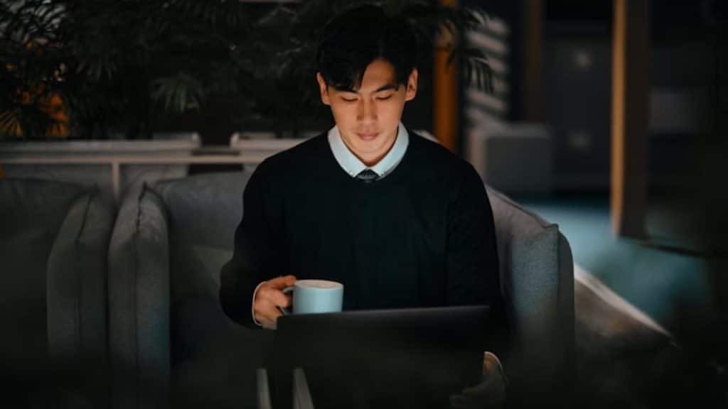 Man reviewing financial charts on his laptop.